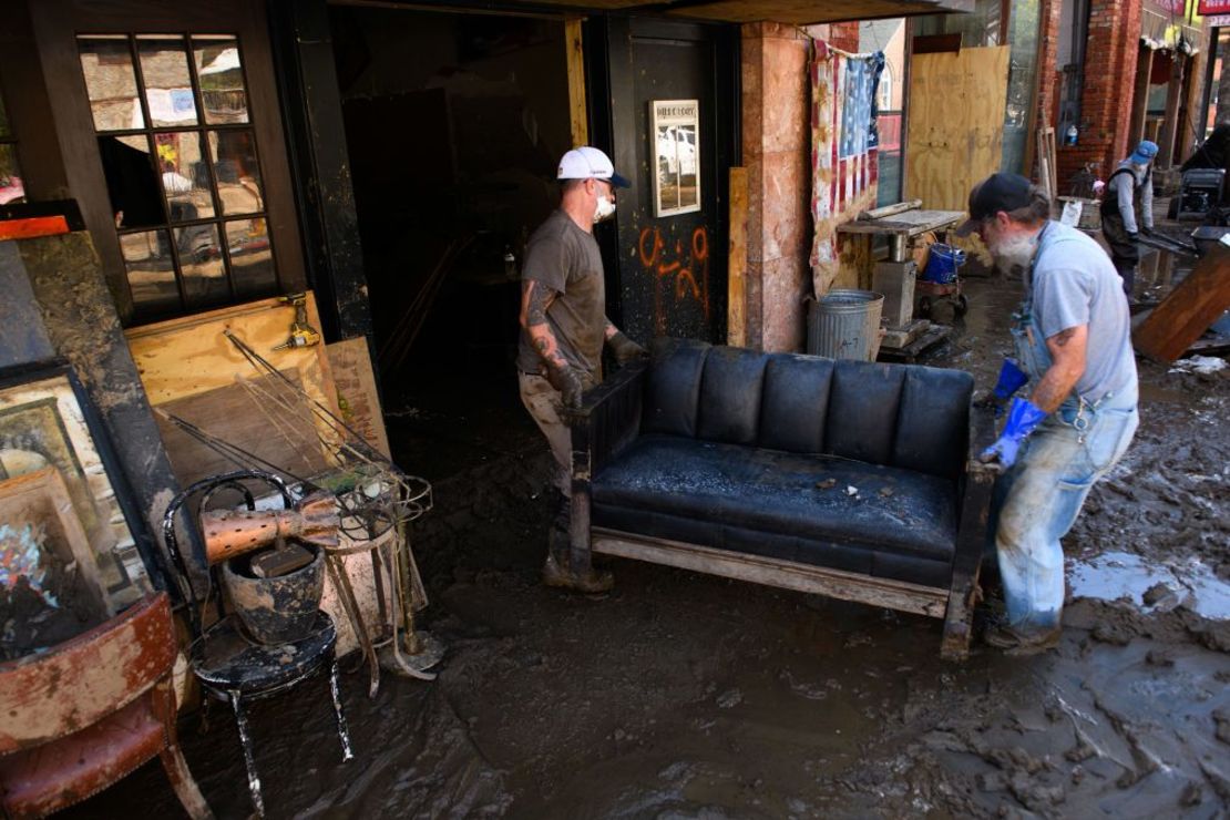 Men remove items from a fine arts business in Marshall, North Carolina, on Thursday. Credit: Melissa Sue Gerrits/Getty Images