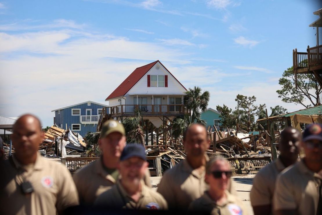 First responders view President Joe Biden's motorcade against the backdrop of damaged properties in Keaton Beach, Florida, on Thursday. Credit: Tom Brenner/Reuters